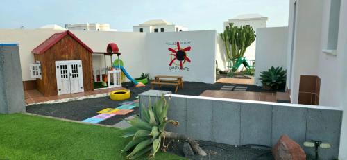 a small backyard with a play area with a playground at Villa Lanzarote Deluxe & Spa Pool in Playa Blanca