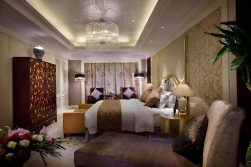 a hotel room with a bed and a couch at Xian Grand Soluxe International Hotel in Xi'an