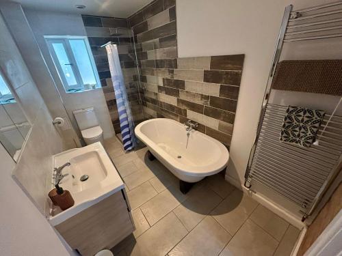 a bathroom with a sink and a toilet and a shower at 7 - Otters Halt, Norfolk in Sparham