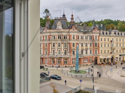 a large building with a plaza in front of it at IMPERIAL Apartments in Karlovy Vary