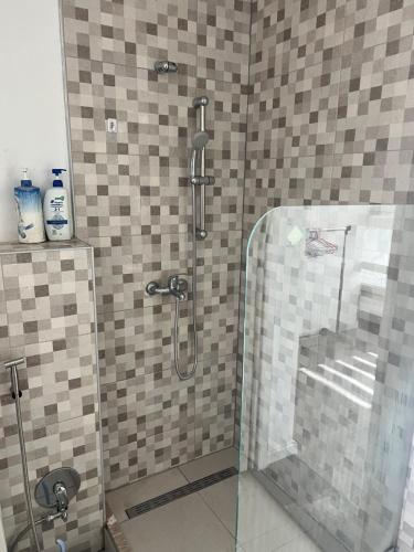 a shower with a glass door in a bathroom at Urban villa in Sarajevo
