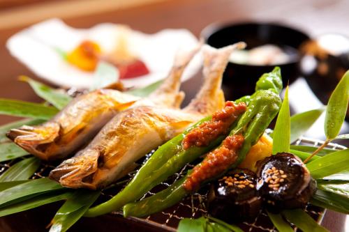 a plate of food with vegetables on a table at Yufuin Souan Kosumosu in Yufuin