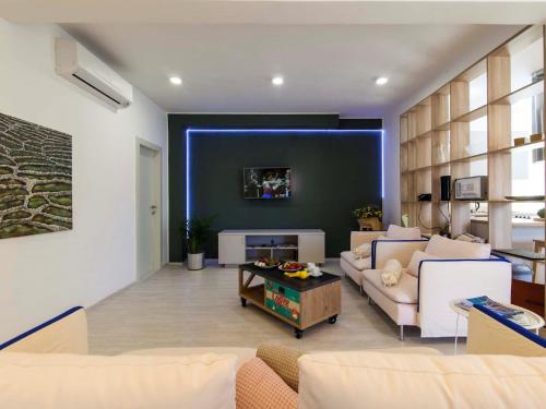 a living room with a couch and a table at Charming Villa with Pool in Šibenik