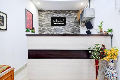 a restaurant entrance with a counter and flowers at Collection O Jyotirindra Nandi Metro Station Kolkata Formerly Hotel Manurama in Jādabpur