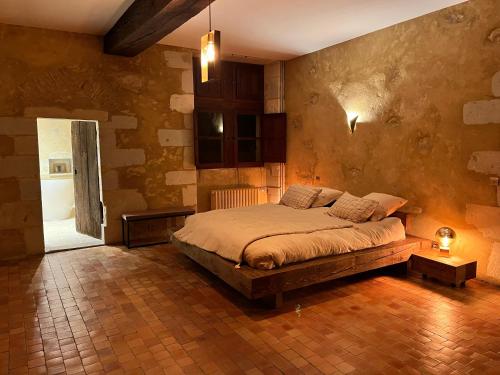 a bedroom with a bed in a room at Seigneurie du Bois Moreau in Durtal