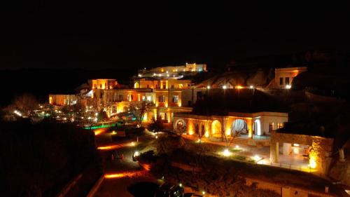 a city lit up at night with lights at MDC Cave Hotel in Urgup