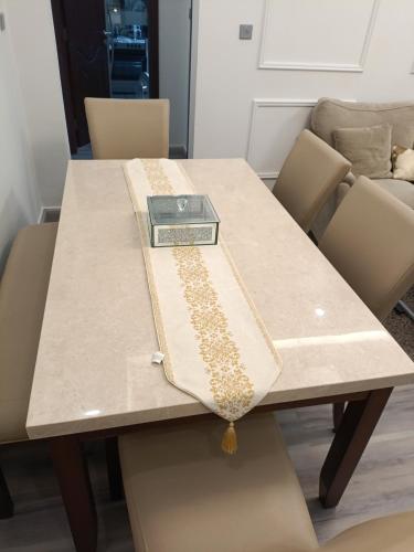 a table with a purse sitting on top of it at Two bedrooms Lusail Apartment in Lusail