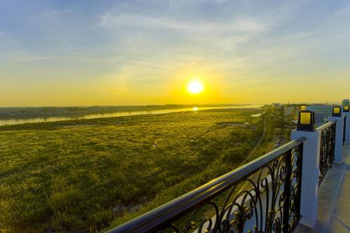 a view of the sunset from a balcony at La Seine Hotel in Vientiane