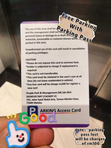 a person holding up a free parking with parking pass card at Imperio Homestay Private Bathtub Melaka Town - Near JONKER STREET in Melaka