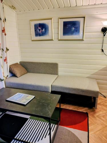 a living room with a couch and a table at Nordnes Kro og Camping in Rokland