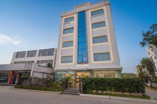 a tall white building with glass windows at Oriva Aditya Homes Nr ISB, Gachibowli in Hyderabad
