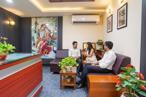a group of people sitting in a waiting room at FabHotel Prestige Nr Maapusa Bus Stop in Guirim