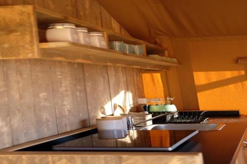 a kitchen with a sink and a counter top at Pleasant tent with swimming pool in Fermo