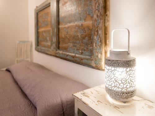 a lamp sitting on a table next to a bed at Pleasant tent with swimming pool in Fermo
