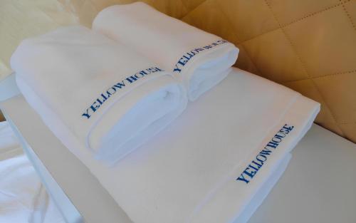 a white cake with a book on top of it at Yellow House in Hengchun