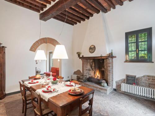 a dining room with a table and a fireplace at Villa in Lombardy near Po River in Stagno Lombardo