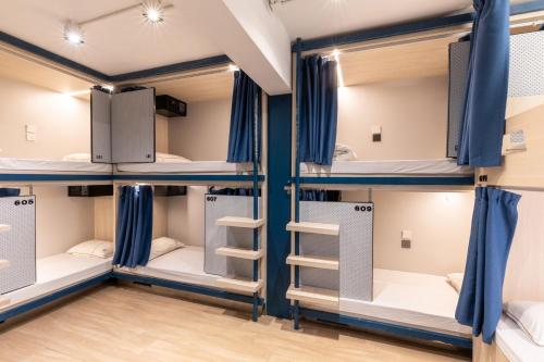 a group of bunk beds in a dorm room at Atlas Hostel & Backpackers in Hong Kong
