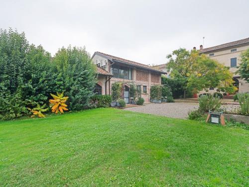 a house with a yard with a grass field at Villa in Lombardy near Po River in Stagno Lombardo