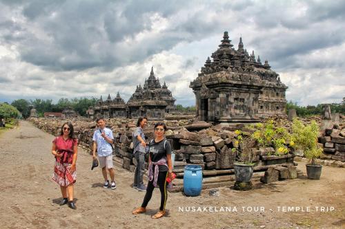 a group of people standing in front of a stone building at Gorga hostel in Timuran
