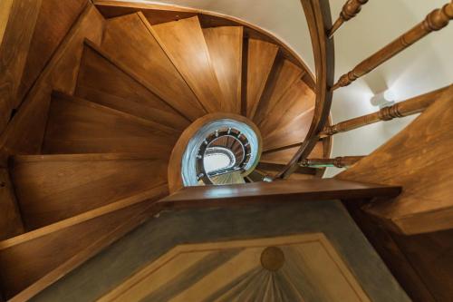 a wooden spiral staircase with a round wooden spiral stair case at Nosteo in Athens