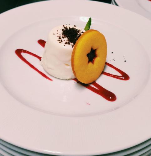 a dessert on a white plate with a piece of food at Hotel Bergblick in Racines