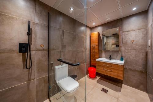 a bathroom with a toilet and a sink at Golfside Serenity - Stylish 1 BHK by FREE Holiday Homes in Ras al Khaimah
