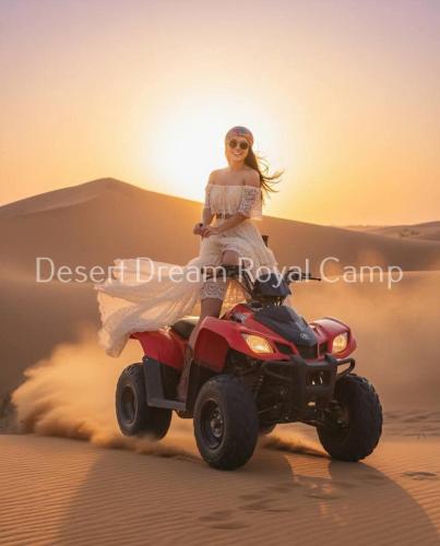 a woman riding a quad bike in the desert at Desert Dream Royal Camp & Pool in Jaisalmer