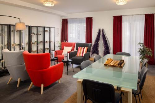 a living room with a chess board on a glass table at Hotel Sonne St. Moritz 3* Superior in St. Moritz