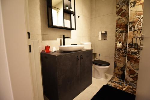 a bathroom with a sink and a toilet at Monkey Loft - Graz City Center & Free Garage Parking in Graz