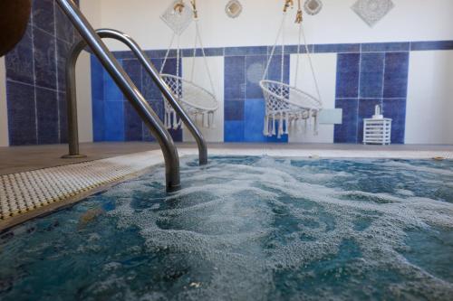 a large swimming pool with a basketball hoop at Hotel Residence - Parco Mare Monte in Ischia