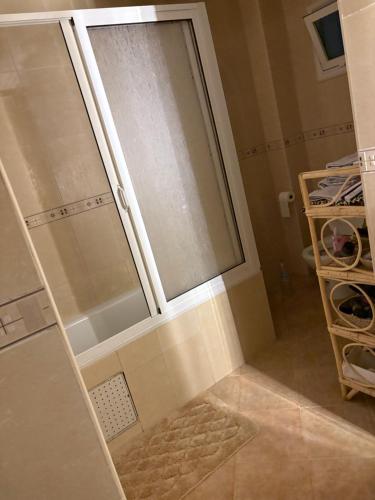 a shower with a glass door in a bathroom at Tanja Pearl in Tangier