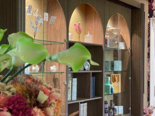 a room with a book shelf filled with items at Villa Pruly Hotel Cannes Centre in Cannes