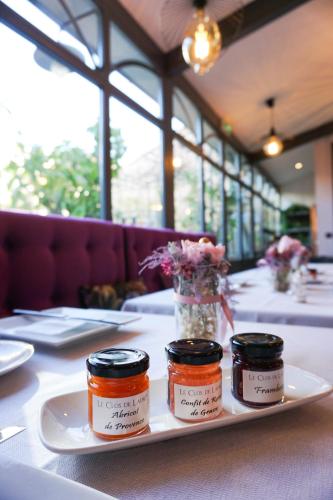 three jars on a plate on a table at Villa Pruly Hotel Cannes Centre in Cannes