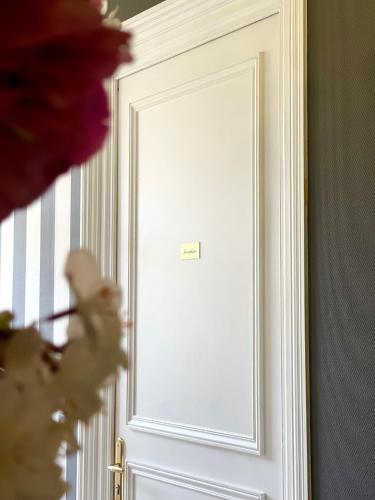 a white door with a sign on it at Villa Pruly Hotel Cannes Centre in Cannes