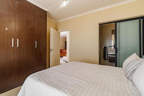 a bedroom with a bed and a sliding glass door at Modern 3-Bed Apartment Perfect for Family & Groups in Vosburg