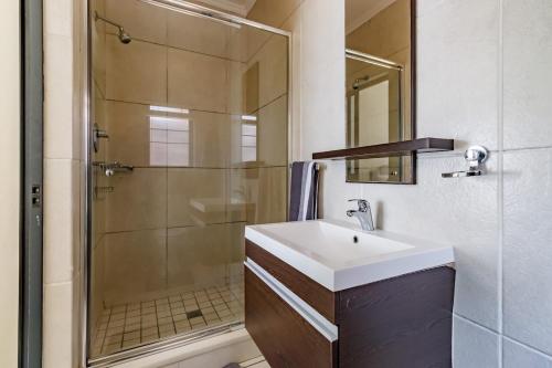 a bathroom with a sink and a shower at Modern 3-Bed Apartment Perfect for Family & Groups in Vosburg