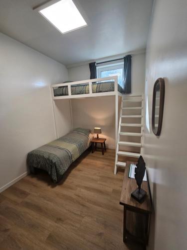 a bedroom with two bunk beds and a staircase at Bed & Breakfast Twekkelo in Enschede