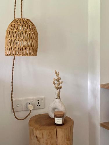 a table with a lamp and a vase on it at Kanferri Villa in Ahangama