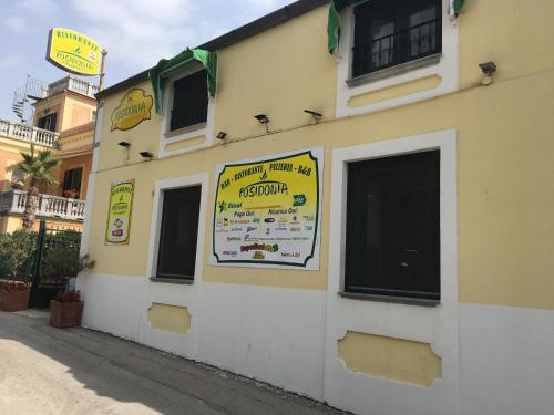 a building with a sign on the side of it at Hotel Poseidonia in Sapri