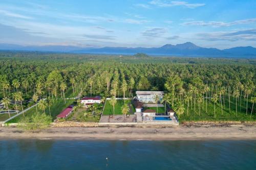 an aerial view of a house on an island in the water at Reboot Retreat Beach Resort, Restaurant, and Coffee Shop in Ban Talat Bang San