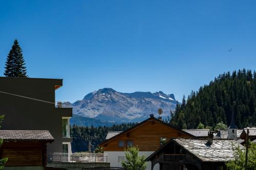 a mountain in the distance with houses and trees at Residenz Panorama - Blatten bei Naters VS in Blatten bei Naters