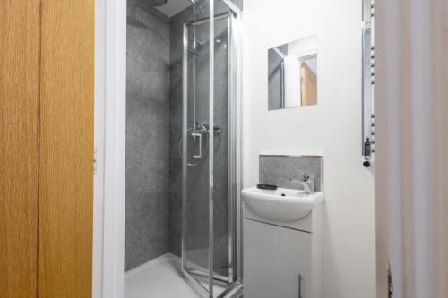 a bathroom with a shower and a sink at St James Court Aparthotel in Derby