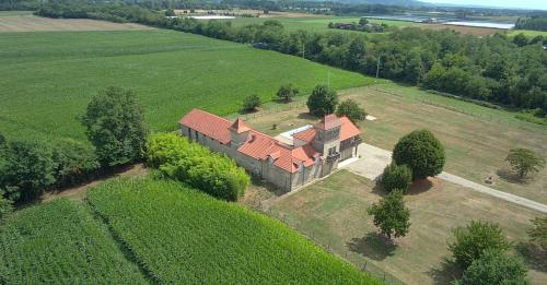 an aerial view of a large house in a field at Gîte atypique au style industriel (Classé 4****) in Feugarolles