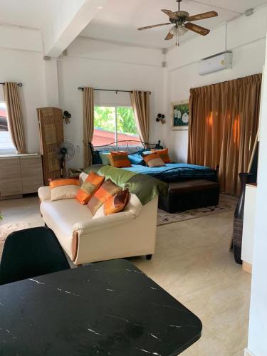 a bedroom with a bed and a couch and a bed at Studio du Bonheur Mer et Nature Rawai beach in Nai Harn Beach