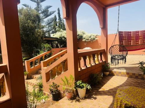 a balcony of a house with a bench and plants at gift for mom in El Jadida