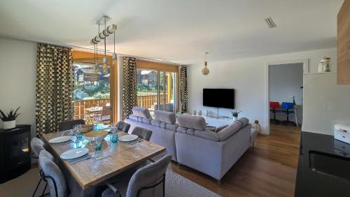 a living room with a couch and a table at Residenz Panorama - Blatten bei Naters VS in Blatten bei Naters