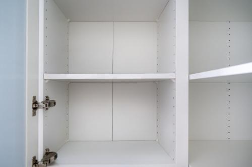 a bathroom with white cabinets and shelves at Residenz Panorama - Blatten bei Naters VS in Blatten bei Naters