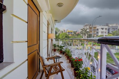 a balcony with a table and chairs and plants at FabHotel New kolkata Residency Inn - Nr Axis Mall in Kolkata