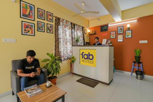 a man sitting in a waiting room at a doctors office at FabHotel New kolkata Residency Inn - Nr Axis Mall in Kolkata