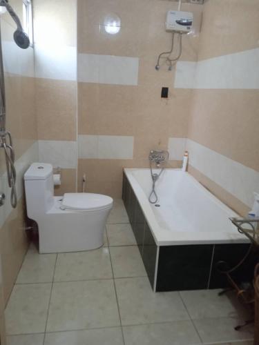 a bathroom with a toilet and a tub and a sink at Studio du Bonheur Mer et Nature Rawai beach in Nai Harn Beach